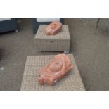 A pair of terracotta wall mask planters.