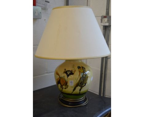 A pottery table lamp painted with a polo playing scene.