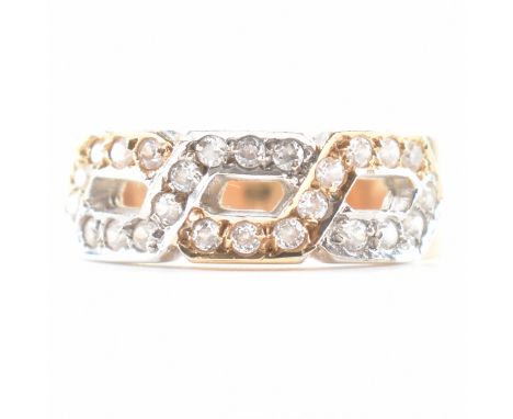 A vintage 14ct two tone gold & white stone set ring. The crossover ring channel set with 24 white round cut stones to a taper