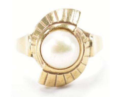 A vintage gold and cultured pearl ring. The ring being set with a cream cultured pearl in a crossover setting. Rubbed mark to