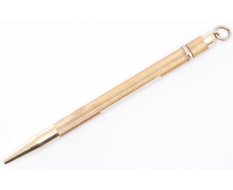 A hallmarked 9ct gold mechanical pencil having an engine turned body with a unengraved initial panel. The pencil having a pen