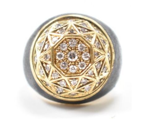 A vintage 18ct gold, diamond &amp; enamel ring. The ring having a domed head of geometric pattern &amp; set with round cut di