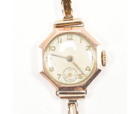 A hallmarked 9ct yellow &amp; rose gold cocktail watch. The wrist watch having a circular cream dial with gold tone Arabic nu