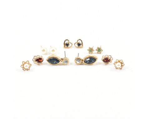 An assorted collection of gold &amp; gold tone earring. The lot to include; Pearl studs, oval cut red stone scalloped head st