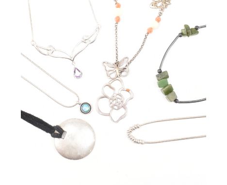 An assorted collection of silver necklaces. The lot to include; circular pendant on black strap, green stone &amp; tubular be