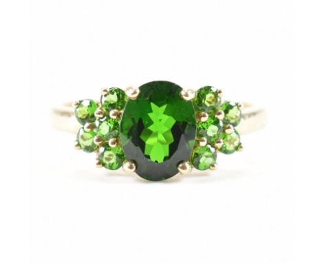 &nbsp;A hallmarked 9ct yellow gold &amp; chrome diopside cluster ring. The ring having an oval cut chrome diopside to the cen