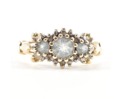 A hallmarked 9ct gold, diamond &amp; aquamarine cluster ring. The ring having three round cut graduating aquamarines surround