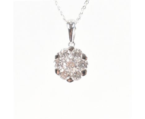 An 18ct white gold &amp; diamond cluster pendant &amp; necklace chain. The pendant having a central round cut diamond surroun