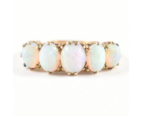 A vintage 18ct yellow gold &amp; opal five stone ring. The ring having five oval cut opal cabochons to scrolling claw setting