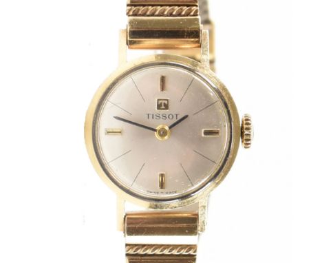 A vintage Tissot cocktail / wrist watch. The watch having a round face with a silver sunburst dial and baton numerals to the 