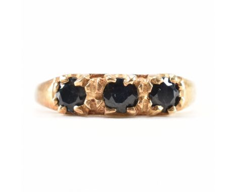 A hallmarked 9ct yellow gold &amp; sapphire ring. The ring having three round cut sapphires to a tapered shank. Hallmarked fo