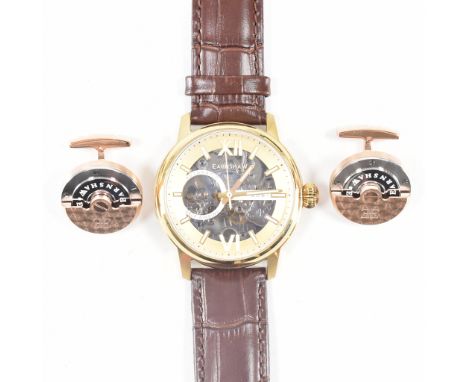An Earnshaw automatic self winding wrist watch. The watch having a round face with exposed mechanism, roman numerals to the c