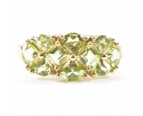 A hallmarked 9ct yellow gold &amp; peridot cluster ring. The ring having a cluster of peridot in various cuts to a prong bask