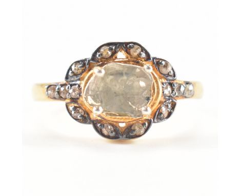 A vintage gold and rough diamond dress ring. The ring being set with a flat rough diamond in a decorative mount set with rose