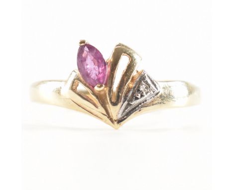 A hallmarked 9ct yellow gold, ruby &amp; diamond ring. The ring having an asymmetrical pierced design head set with a marquis