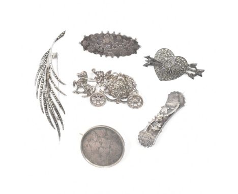 An assorted collection of silver brooch pins. The lot to include; marcasite set horse &amp; carriage with cherub driver, circ