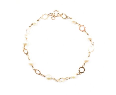 A vintage gold and cultured pearl bracelet. The bracelet having a pierced floral links with alternating cultured pearls. Mark