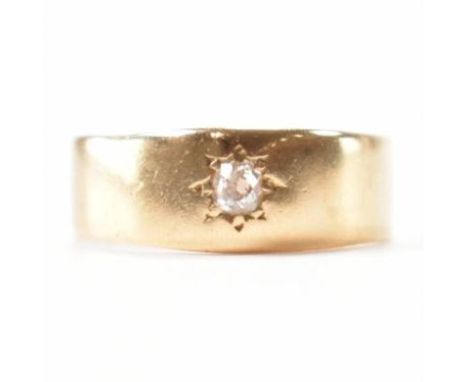 A vintage 18ct gold &amp; solitaire diamond gypsy ring. The ring having a central old cut star set diamond to a plain band. M