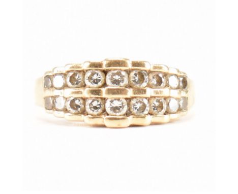 A hallmarked 14ct yellow gold &amp; diamond ring. The ring having two rows of nine graduating round cut diamonds in a stepped