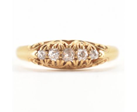 A 19th Century Victorian 18ct gold and diamond ring. The ring being set with five round cut diamonds within a scrolled mount.