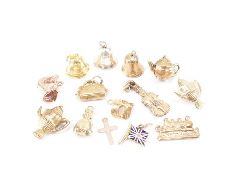 A collection of vintage 9ct gold and yellow metal vintage charms. The lot to include an enamelled union jack flag charm, thre