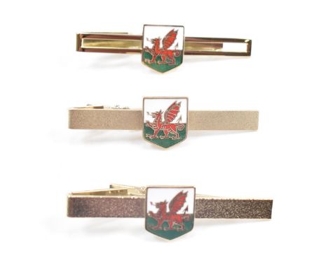 A collection of vintage Stratton Welsh enamelled tie pins. Each in having a square enamelled panel to the centre and set with