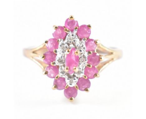 A hallmarked 9ct yellow gold, ruby &amp; diamond cluster ring. The ring having a central marquise cut ruby surrounded by a ha