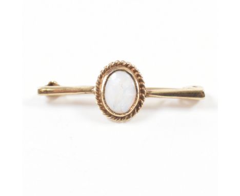 A hallmarked 9ct gold and opal bar brooch. The brooch being set with an oval opal to the centre (AF). Hallmarked Birmingham. 