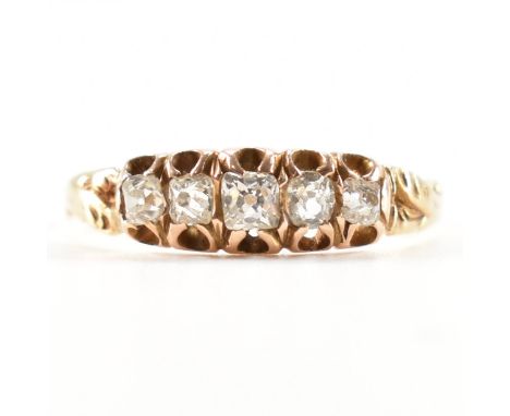 An antique gold &amp; diamond five stone ring. The ring having five graduating old cut diamonds to buttercup setting to split