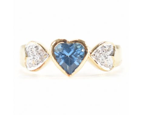 A group of eight silver and gold plated blue and white stone rings. Each ring set with a central heart cut blue stone, flanke