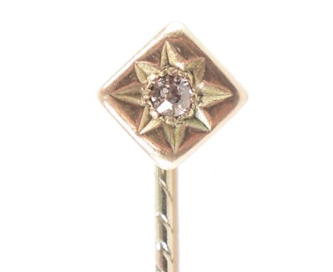 A vintage gold and diamond stick pin. The pin having a square head set with a round old cut diamond to a twist design stick p