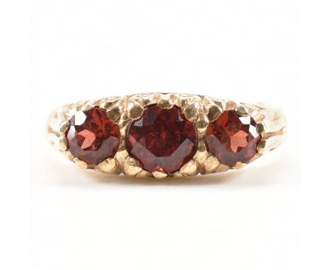 A hallmarked 9ct gold and red stone ring. The ring being set with three round cut garnets. Hallmarked Birmingham 1988. Weight