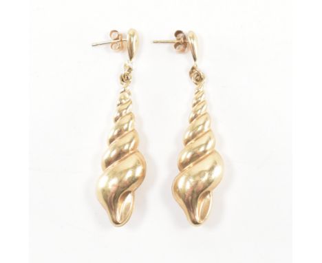 A pair of vintage gold drop earrings. The earrings in the form of spiralling conch shells. Earrings unmarked, tests indicate 