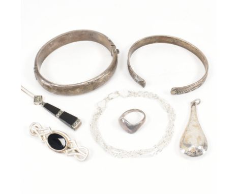 An assortment of silver jewellery. The lot to include a three chain silver bracelet, silver hinged bangle, open bangle, onyx 