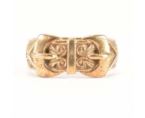 A hallmarked 9ct yellow gold twin buckle ring. The ring moulded in the form of a scrolling design belt fastened with double b