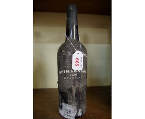A bottle of Fonseca Guimaraens 1986 vintage port.  Condition Report: Provenance: From the estate of the late actor Geoff Hugh