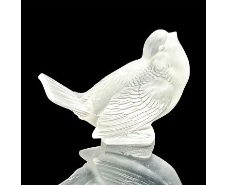 A frosted figure of a sparrow with feather details. R. Lalique etched on the base. Dimensions: 4.5"L x 2.5"W x 3.25"HManufact