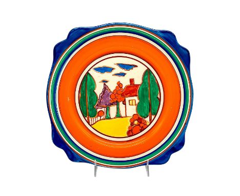 A hand painted Art Deco scalloped broth plate decorated in an abstract geometric landscape in a colorful palette. Clarice Cli