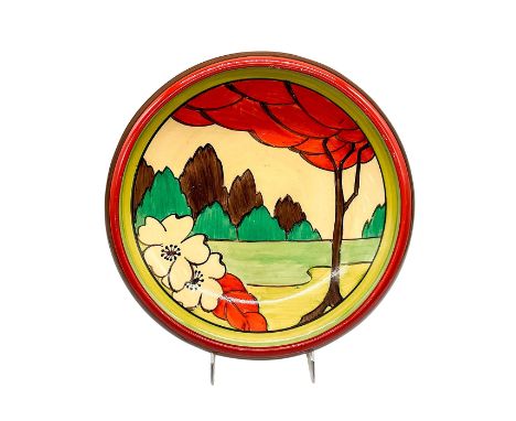 A hand painted Art Deco pointed round bowl decorated in an abstract geometric landscape in a colorful palette. Clarice Cliff 