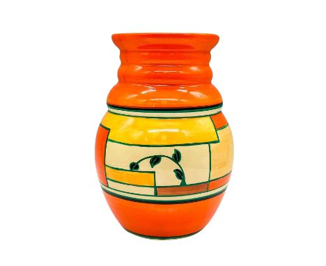 A hand painted Art Deco vase decorated in an abstract geometric design in a colorful palette. Clarice Cliff for Newport Potte