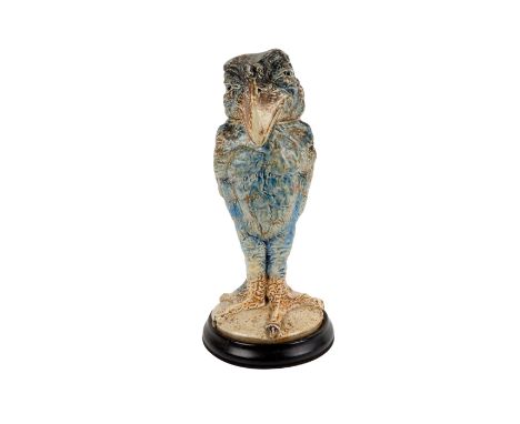 Martin Ware modeled as a grotesque bird standing, glazed in tones of blue, green and brown on ebonized wood base. Cover and b