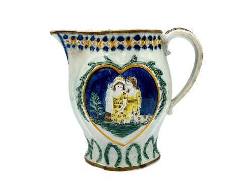 A hand painted prattware pitcher depicting two heart-shaped reliefs with two young girls with a doll. Issued: c. 19th century