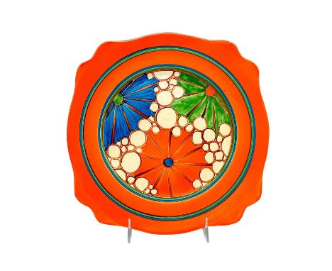 A hand painted Art Deco ceramic scalloped broth plate decorated in an abstract floral pattern in a colorful palette. Clarice 