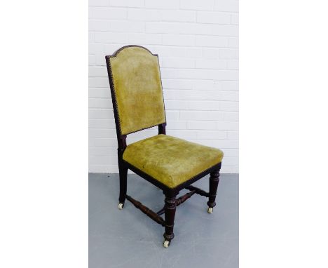 Victorian side chair the back and seat upholstered in green suede raised on turned supports and stretcher terminating on cera