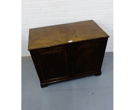 A 19th century mahogany cabinet, having a moulded top over a pair of panel doors enclosing an adjustable shelf, raised on bra