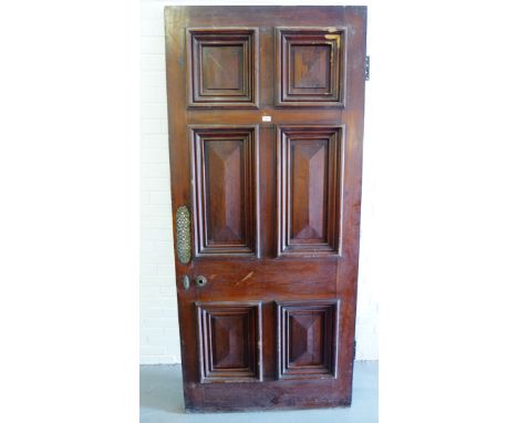 Architectural Salvage - Georgian stained pine panel door having a brass finger plate and lock, with damage to top right panel