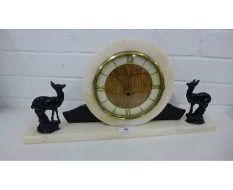 Art Deco white hardstone mantle clock, the circular dial with Roman quarter numerals flanked by a pair of black glazed deer f