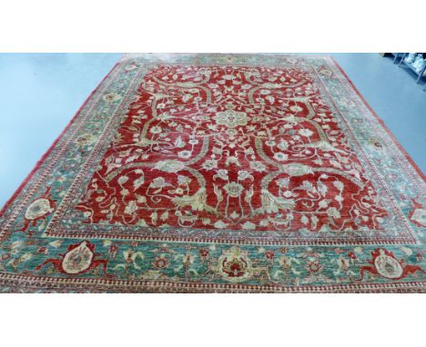 A large Persian carpet having an all over foliage design on a red field, 408 x 351cm