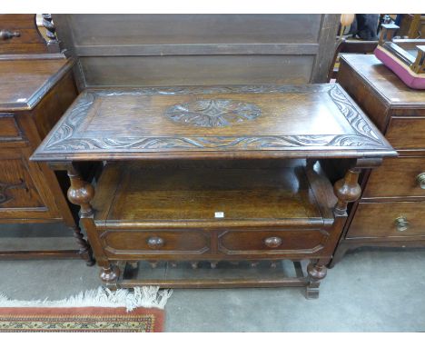 A carved oak monks bench