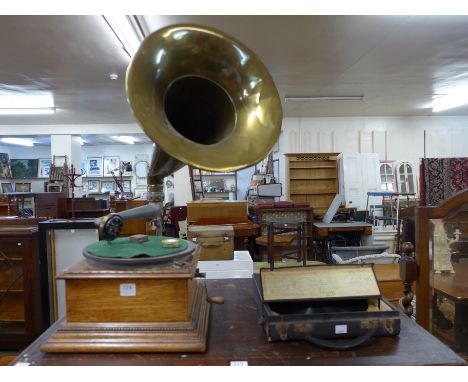 An oak table top gramophone with brass speaker